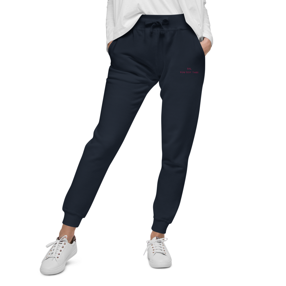 Person wearing navy jogger pants with an embroidered text that reads, sis, you got this on a white background